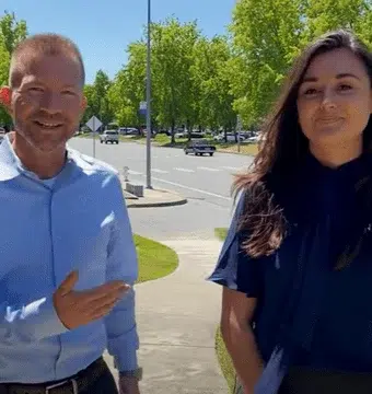 Ryan Kelly and Julianna Ferrara discuss ADA websites while walking outside.