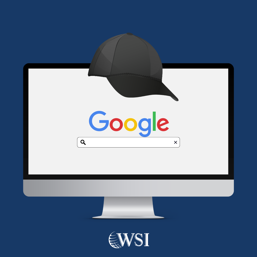 Nay background with the Google search engine on a computer screen with a black baseball cap on top.