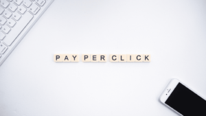 A computer and smartphone surround the words “Pay Per Click”.