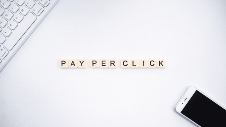 A computer and smartphone surround the words “Pay Per Click”.