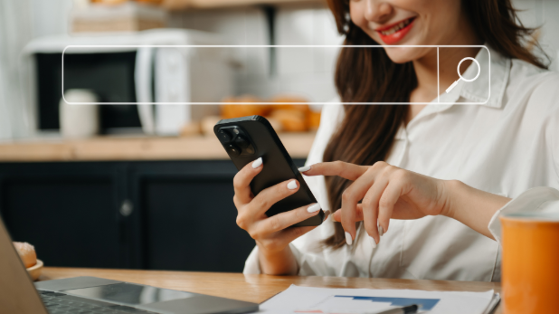A woman searches on her smart phone, with a search bar graphic imposed on the photo.